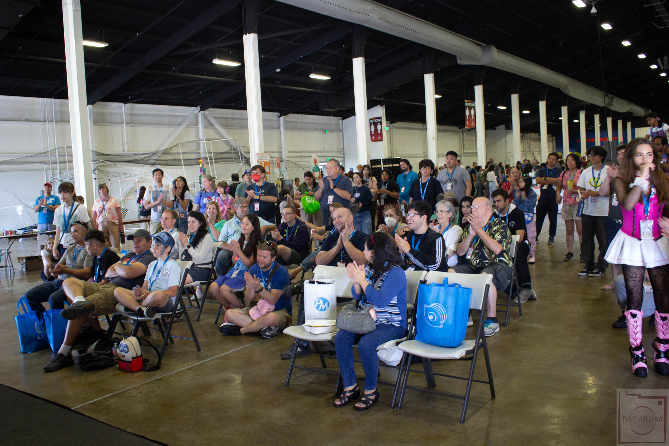 Crowd sitting in chairs